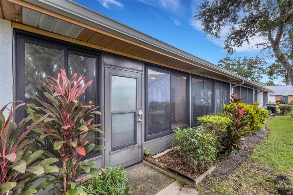 1065 Tartan Drive, Unit C Palm Harbor, FL 34684 - Photo 39 of 91 a front view of a house with garden