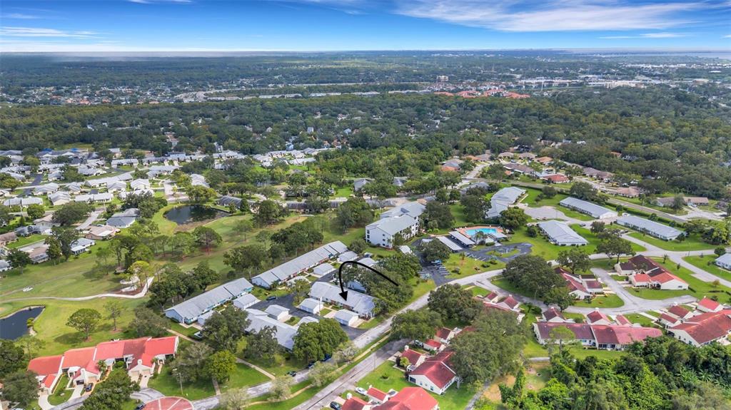 1065 Tartan Drive, Unit C Palm Harbor, FL 34684 - Photo 45 of 91 an aerial view of residential houses with outdoor space