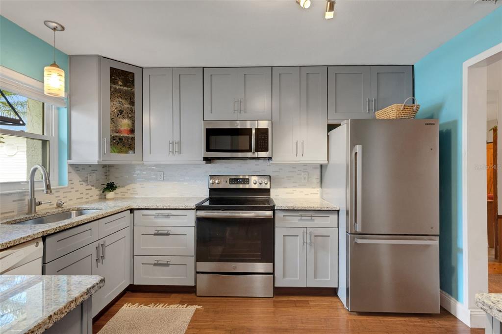 1065 Tartan Drive, Unit C Palm Harbor, FL 34684 - Photo 6 of 91 a kitchen with stainless steel appliances a refrigerator stove and sink