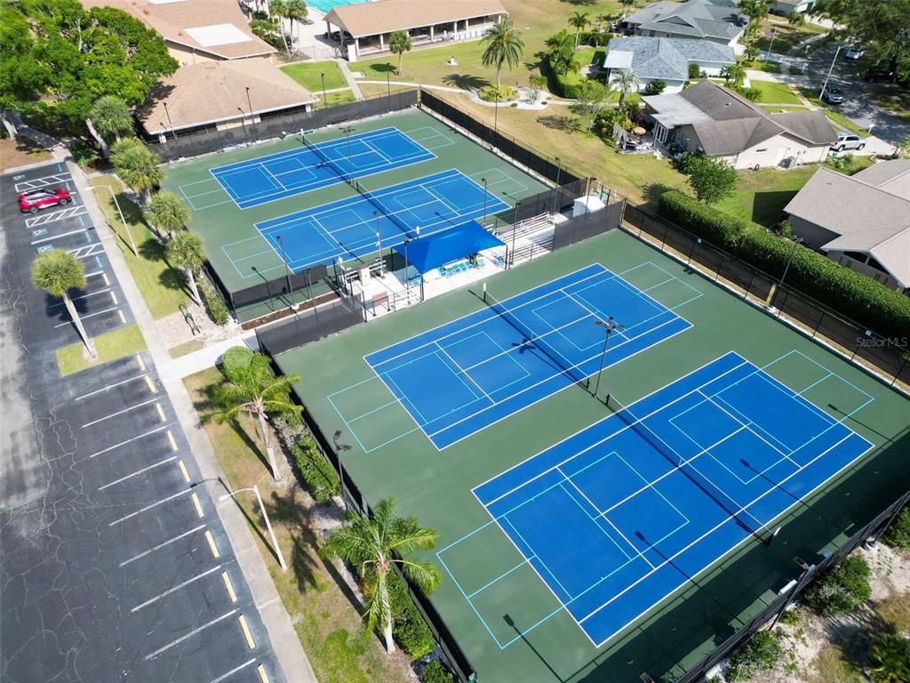 1065 Tartan Drive, Unit C Palm Harbor, FL 34684 - Photo 66 of 91 an aerial view of a tennis ground with large trees