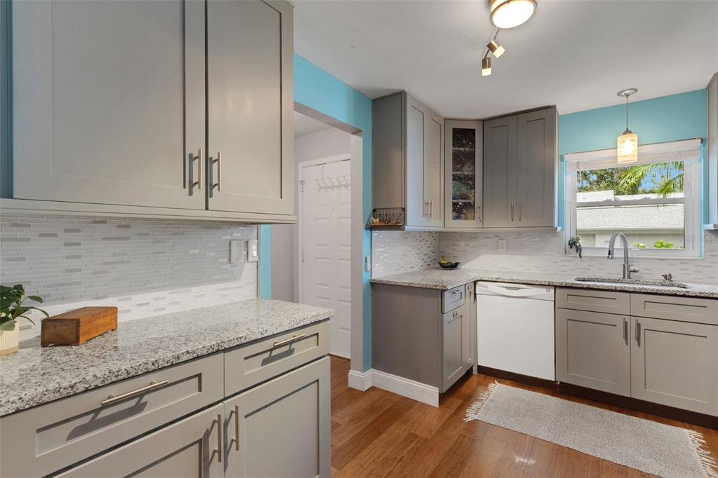 1065 Tartan Drive, Unit C Palm Harbor, FL 34684 - Photo 7 of 91 a kitchen with granite countertop stainless steel appliances sink stove and cabinets