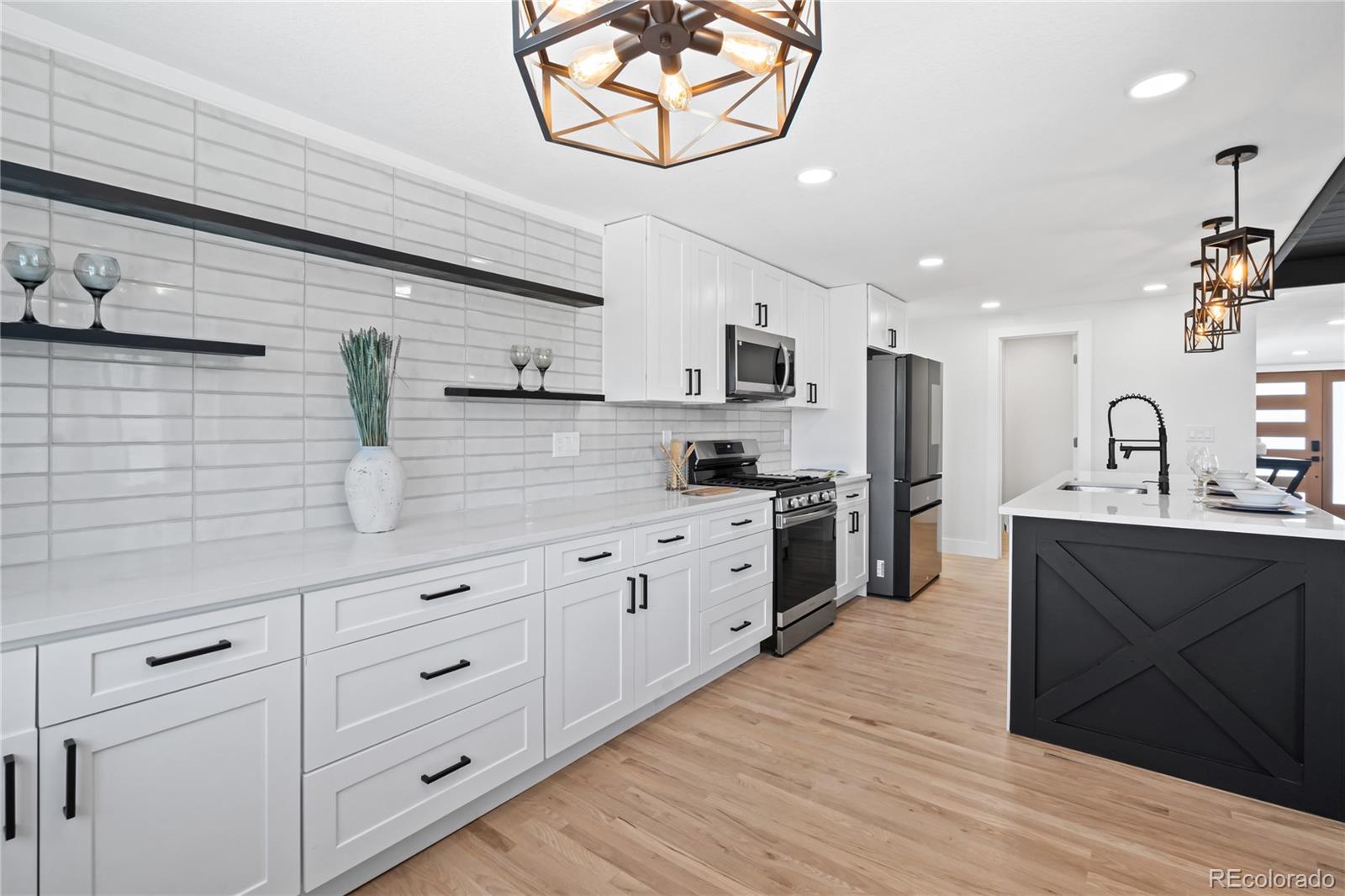 6766 Zenobia Loop Westminster, CO 80030 - Photo 12 of 50 a kitchen with cabinets a sink and appliances