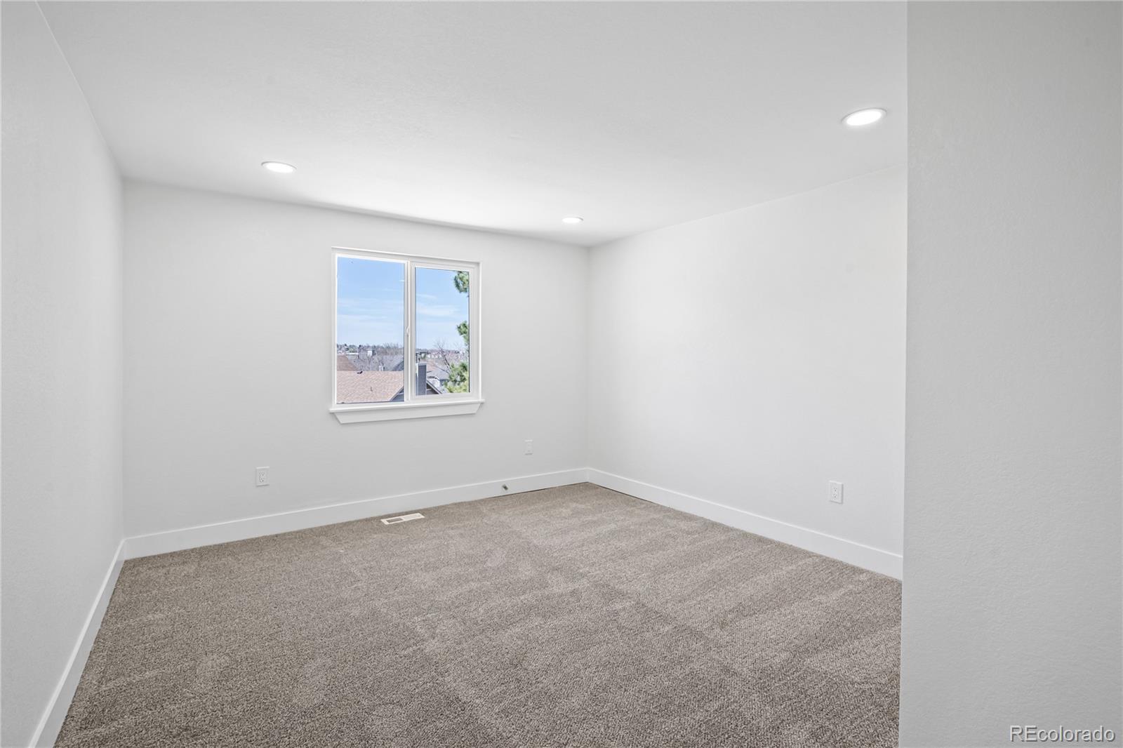 6766 Zenobia Loop Westminster, CO 80030 - Photo 21 of 50 an empty room with wall painting and window