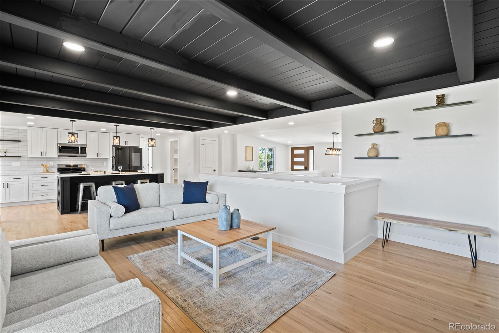 6766 Zenobia Loop Westminster, CO 80030 - Photo 24 of 50 a living room with furniture and kitchen view