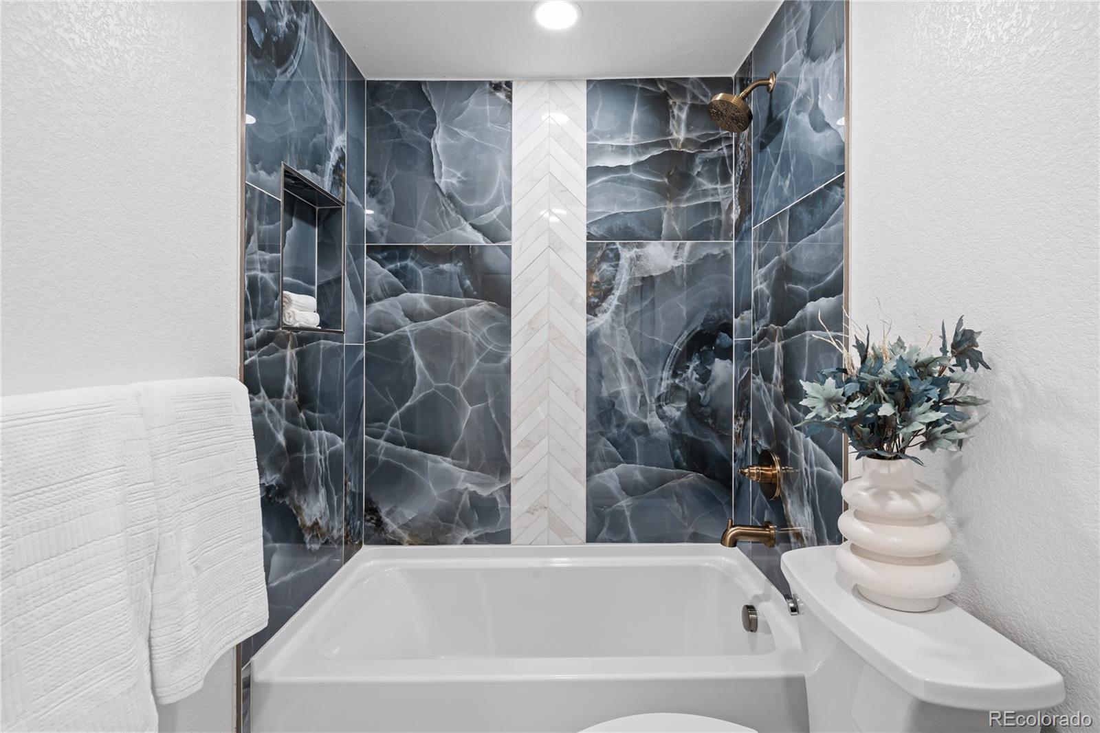 6766 Zenobia Loop Westminster, CO 80030 - Photo 27 of 50 a bathroom with a bathtub and shower