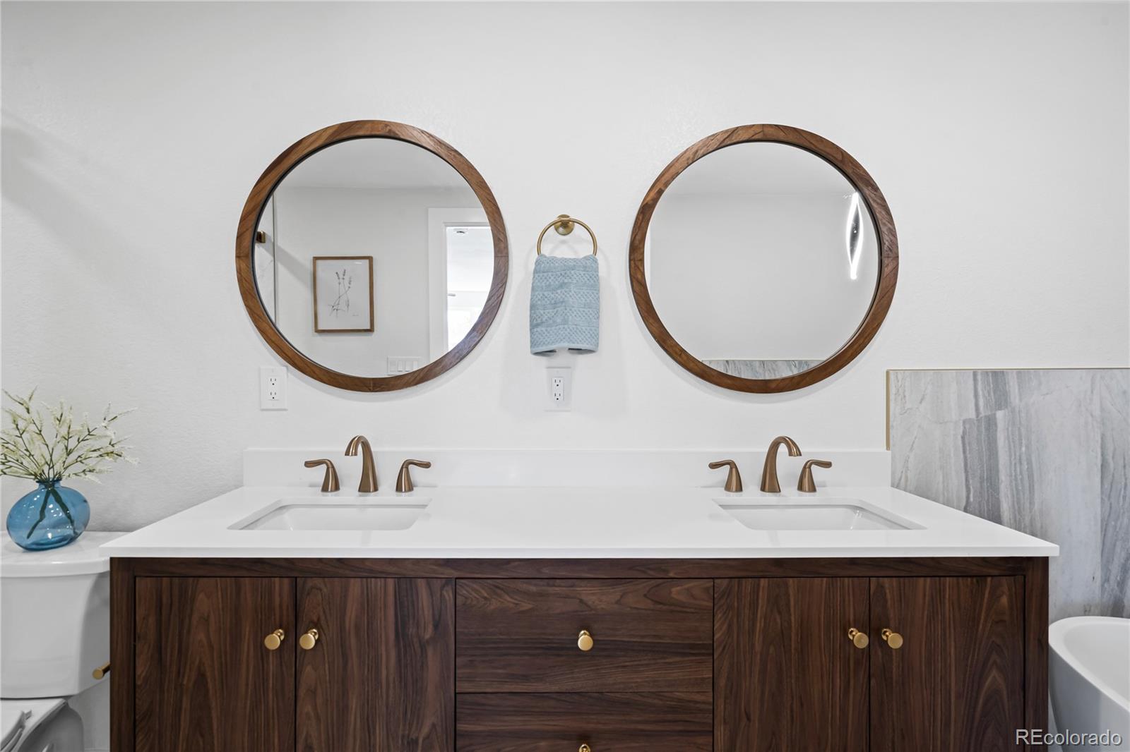 6766 Zenobia Loop Westminster, CO 80030 - Photo 34 of 50 a bathroom with a sink and a mirror