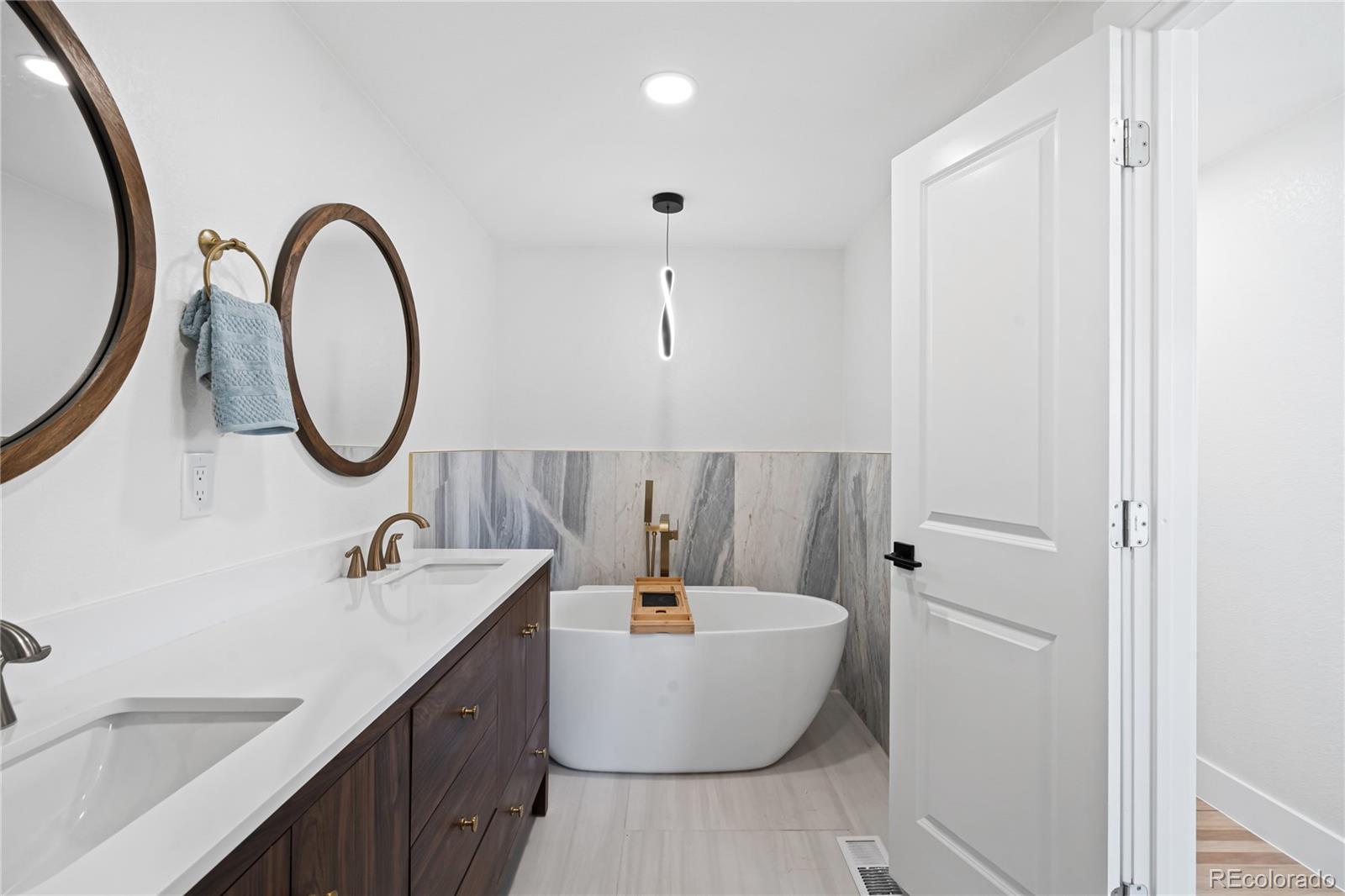 6766 Zenobia Loop Westminster, CO 80030 - Photo 35 of 50 a bathroom with a bathtub and a sink