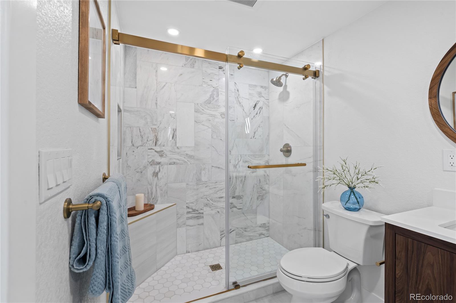 6766 Zenobia Loop Westminster, CO 80030 - Photo 36 of 50 a bathroom with a shower a toilet and sink