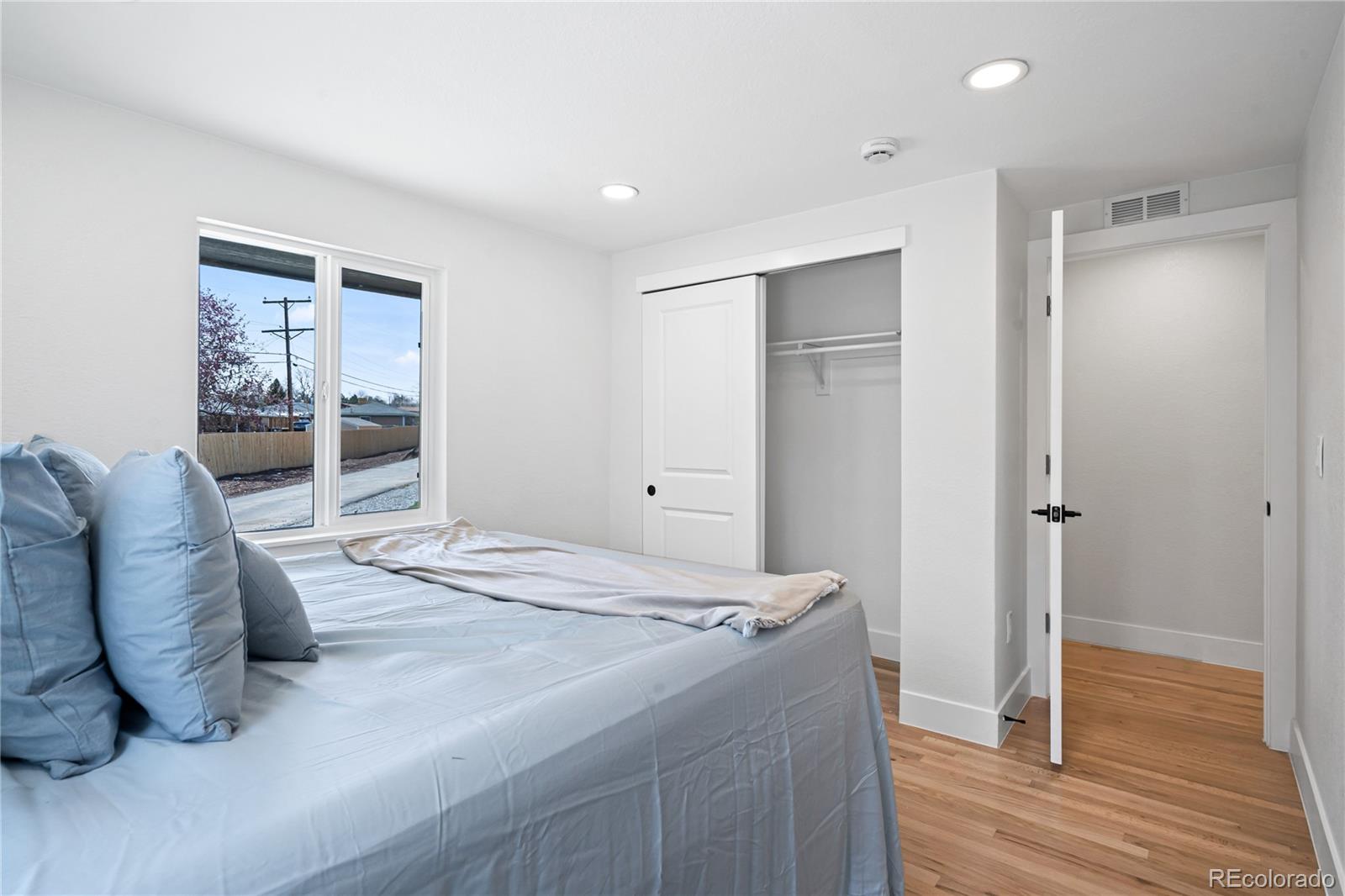 6766 Zenobia Loop Westminster, CO 80030 - Photo 37 of 50 a bedroom with a bed and a large window