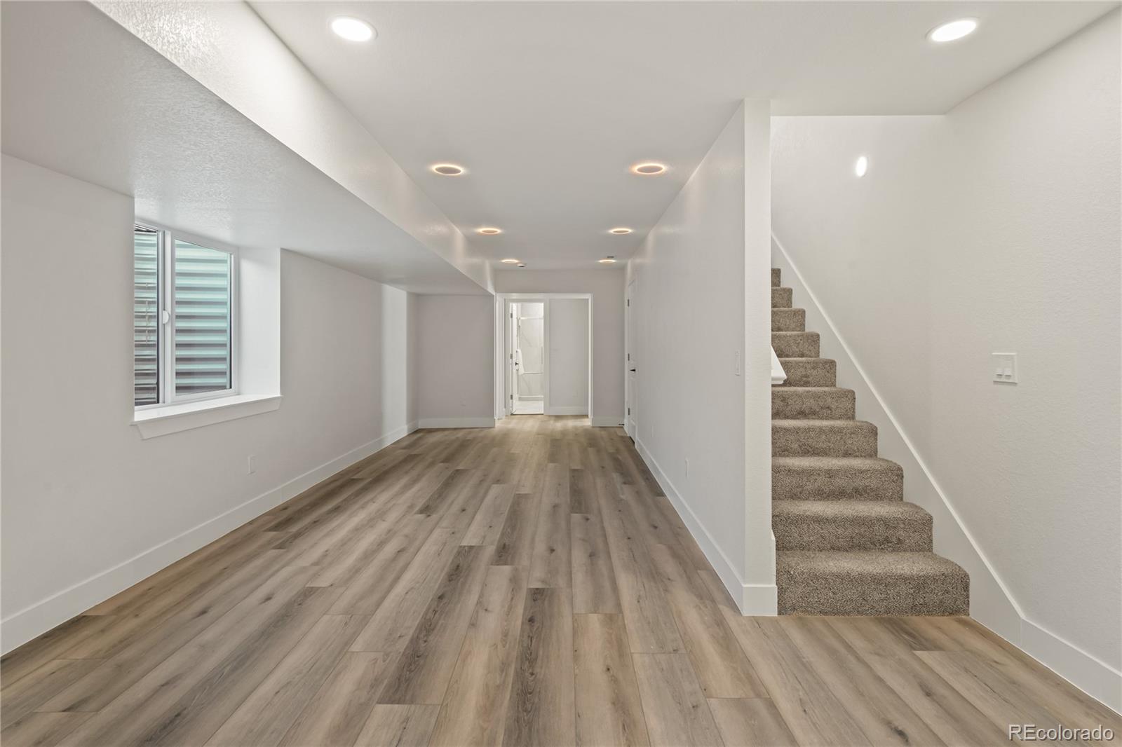 6766 Zenobia Loop Westminster, CO 80030 - Photo 39 of 50 wooden floor in an empty room with a window