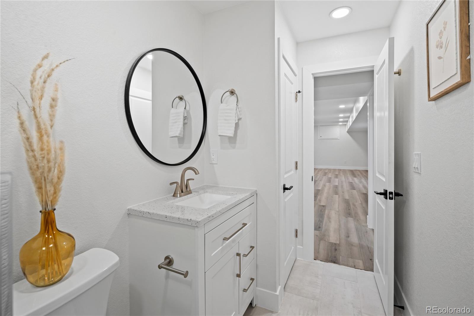 6766 Zenobia Loop Westminster, CO 80030 - Photo 42 of 50 a bathroom with a sink and a mirror