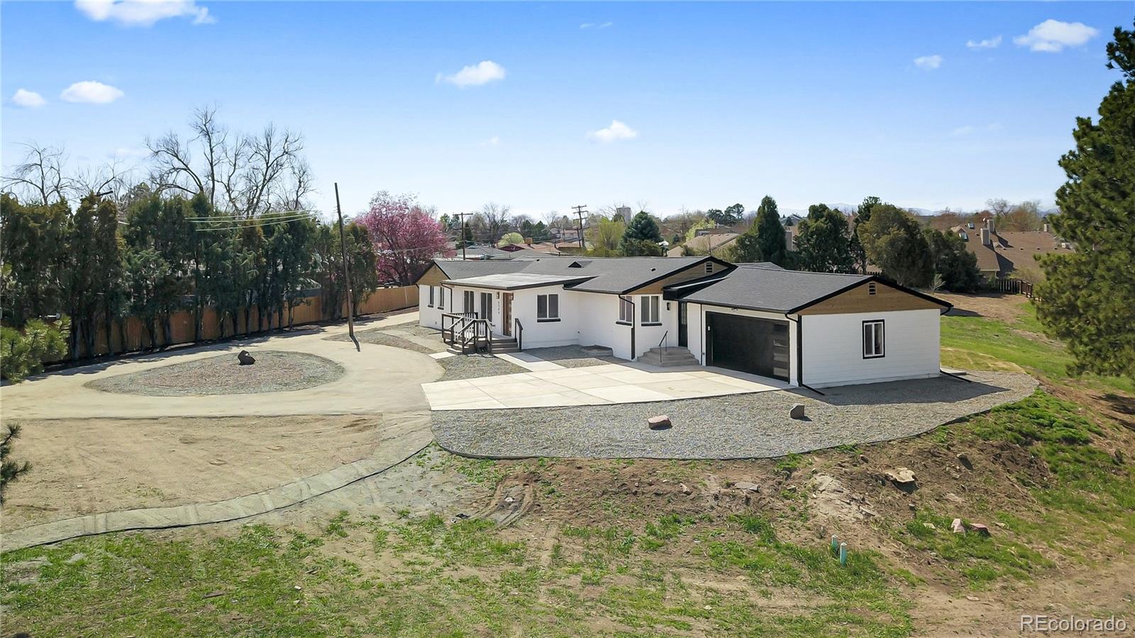 6766 Zenobia Loop Westminster, CO 80030 - Photo 48 of 50 a view of a house with a tub and trees in the background