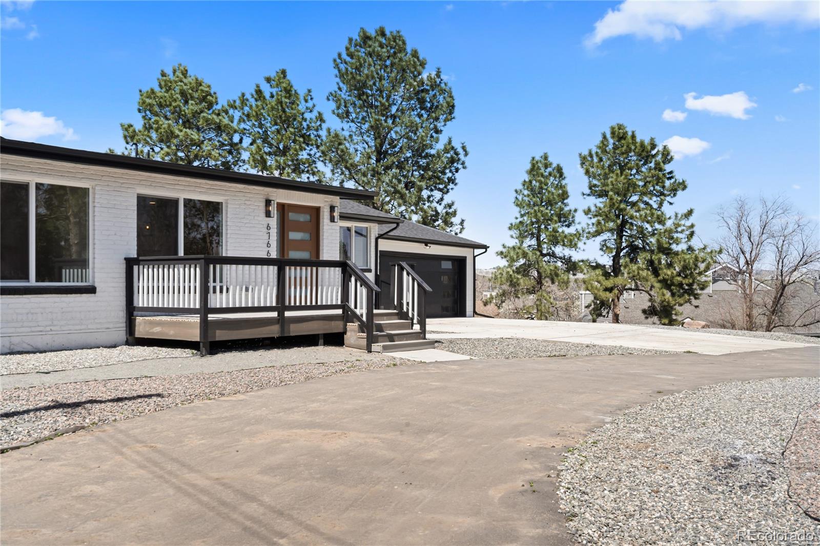 6766 Zenobia Loop Westminster, CO 80030 - Photo 5 of 50 a view of a house with a yard and garage
