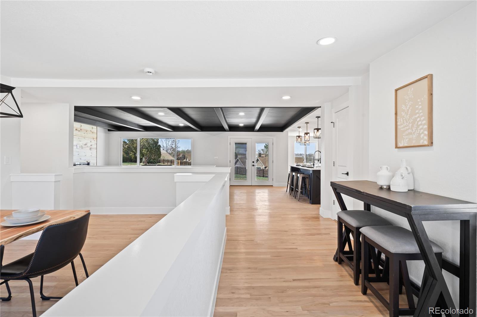 6766 Zenobia Loop Westminster, CO 80030 - Photo 6 of 50 a view of a dining room with furniture and wooden floor
