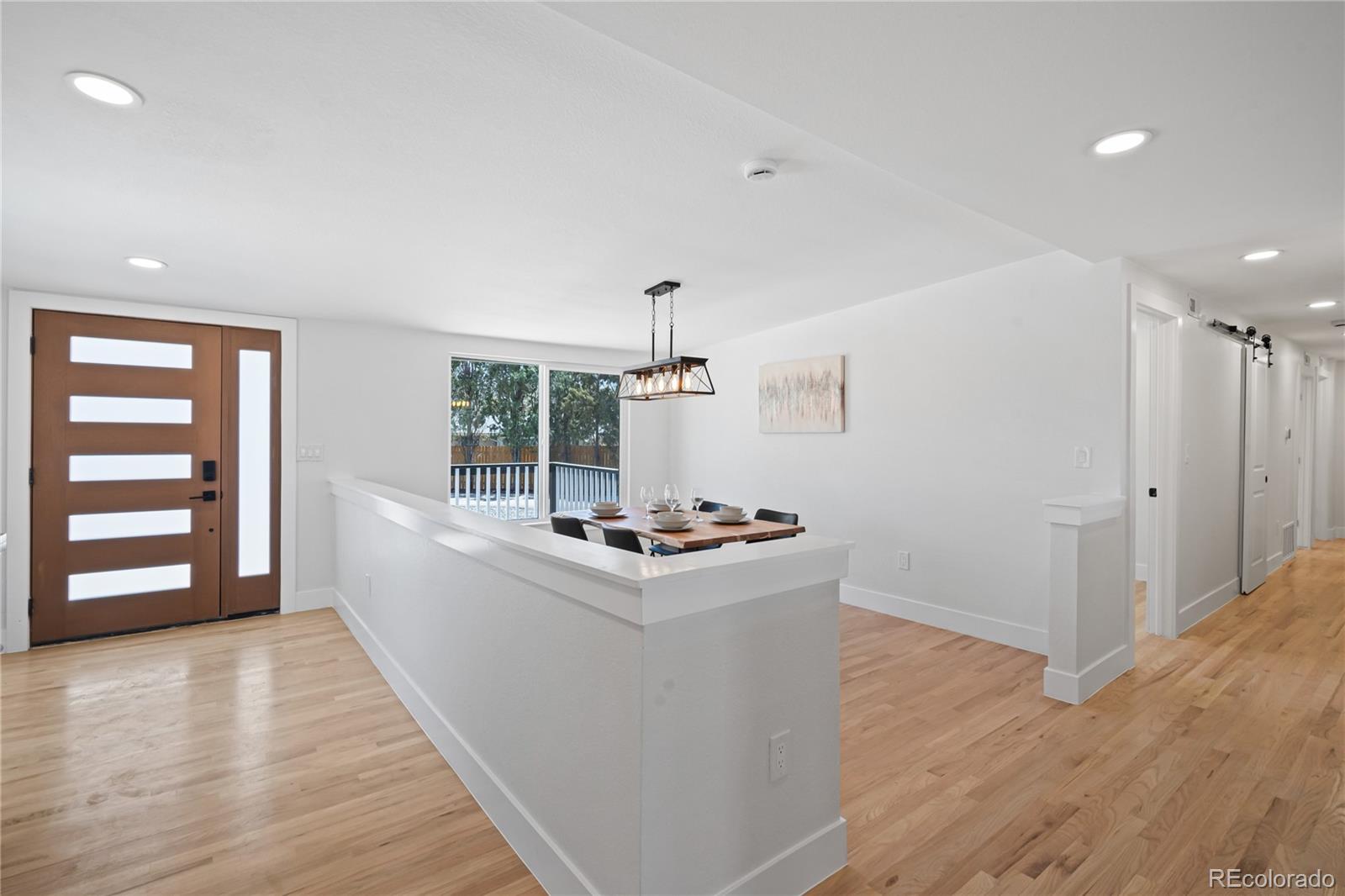6766 Zenobia Loop Westminster, CO 80030 - Photo 7 of 50 a kitchen with sink and wooden floor
