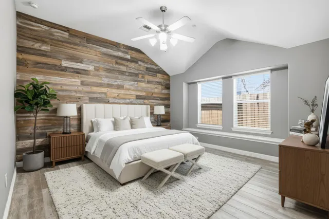 a view of an empty room with a window and a chandelier fan