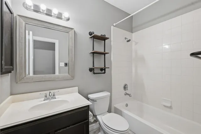 a view of a bedroom with window and ceiling fan