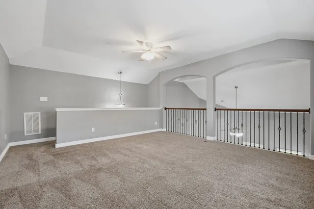 a view of an empty room with a ceiling fan