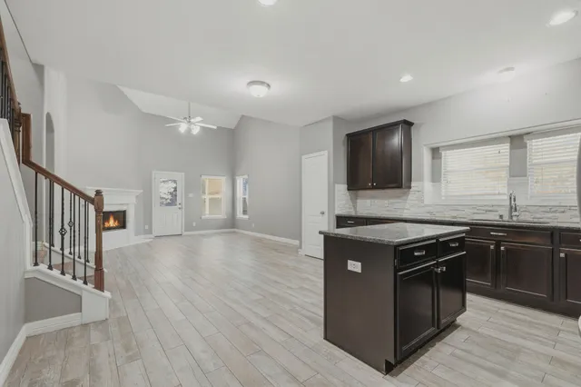 a kitchen with stainless steel appliances granite countertop a stove and a sink