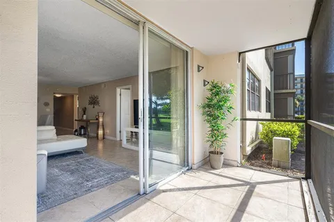 a bedroom with a bed and large windows