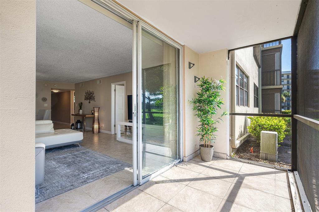 2440 DC Country Club Boulevard, Unit 111C Deerfield Beach, FL 33442 - Photo 21 of 43 a bedroom with a bed and large windows