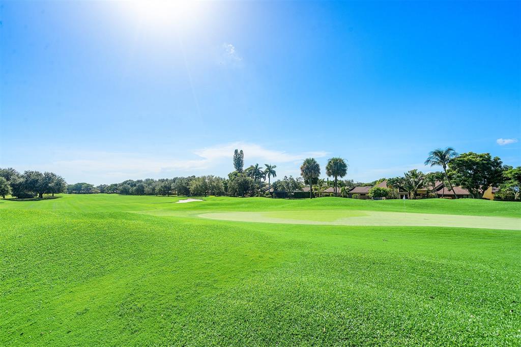 2440 DC Country Club Boulevard, Unit 111C Deerfield Beach, FL 33442 - Photo 25 of 43 a view of a green field with clear sky