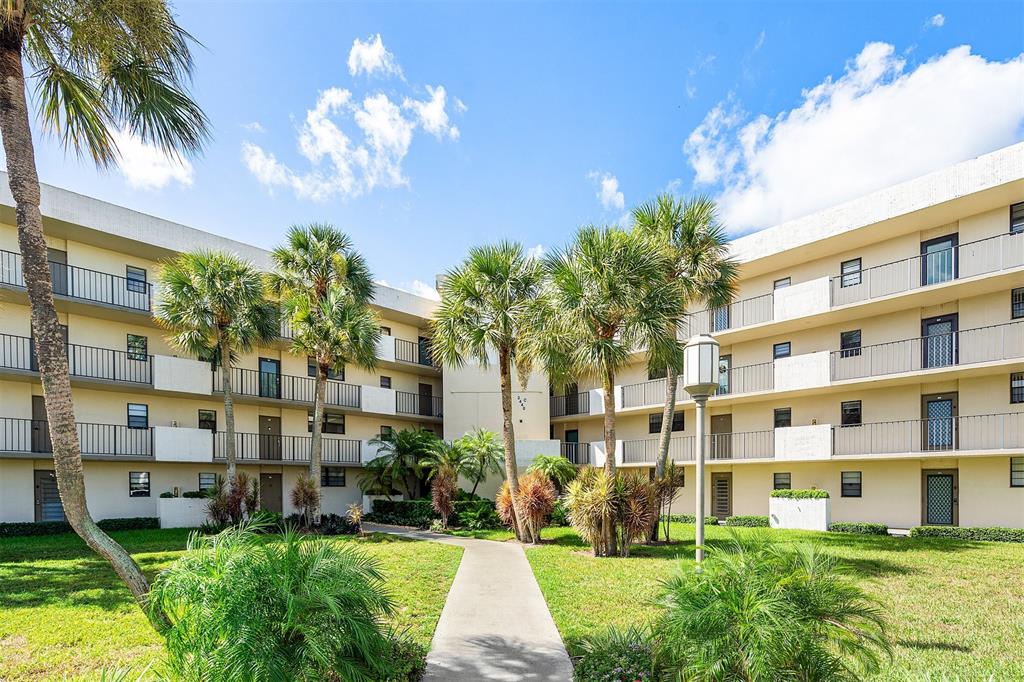 2440 DC Country Club Boulevard, Unit 111C Deerfield Beach, FL 33442 - Photo 32 of 43 a view of a building with a garden