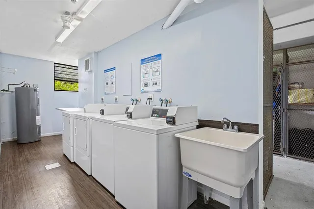 a room with a sink wooden floor and furniture