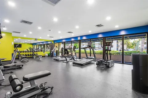 a view of a room with gym equipment and a large window