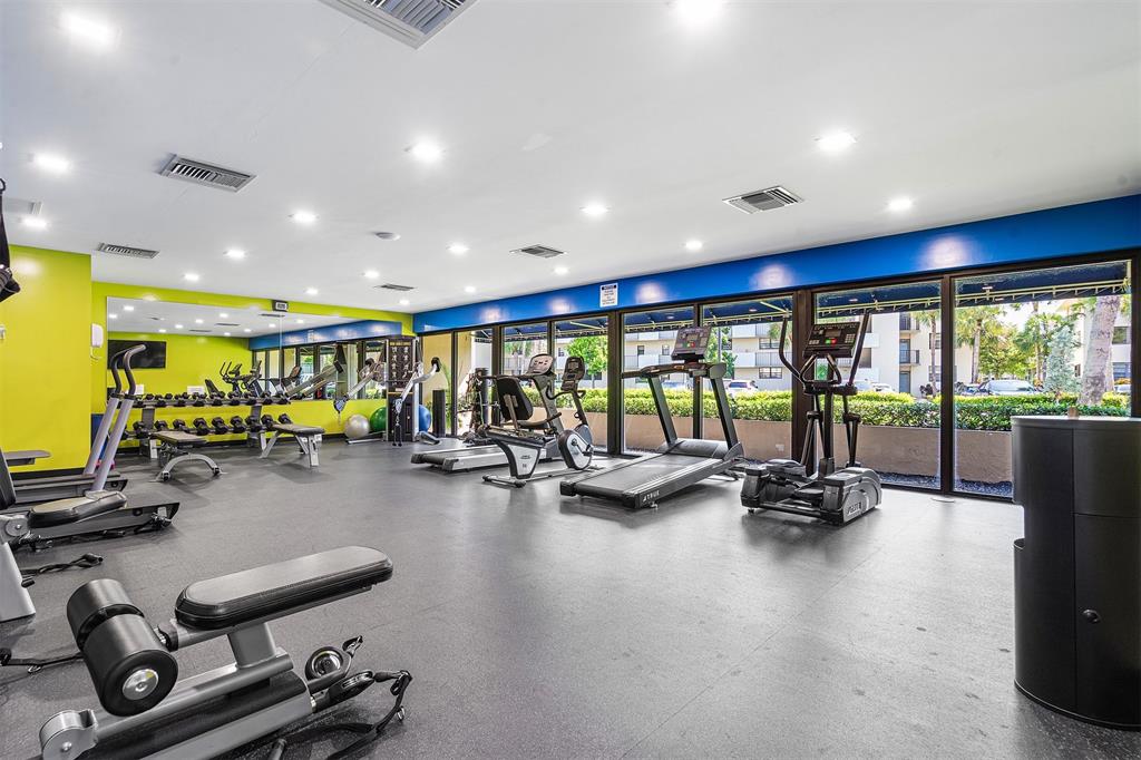 2440 DC Country Club Boulevard, Unit 111C Deerfield Beach, FL 33442 - Photo 34 of 43 a view of a room with gym equipment and a large window
