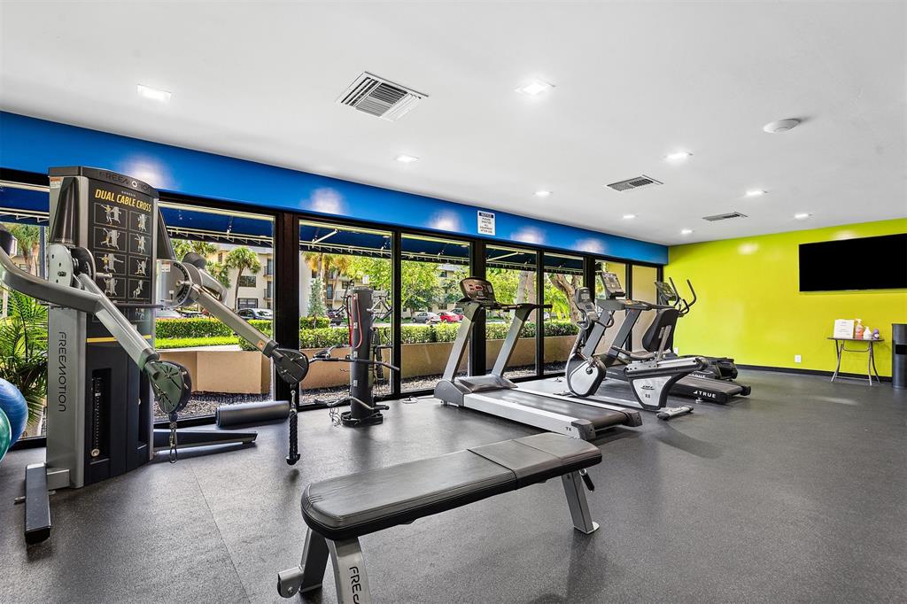 2440 DC Country Club Boulevard, Unit 111C Deerfield Beach, FL 33442 - Photo 36 of 43 a view of a room with gym equipment
