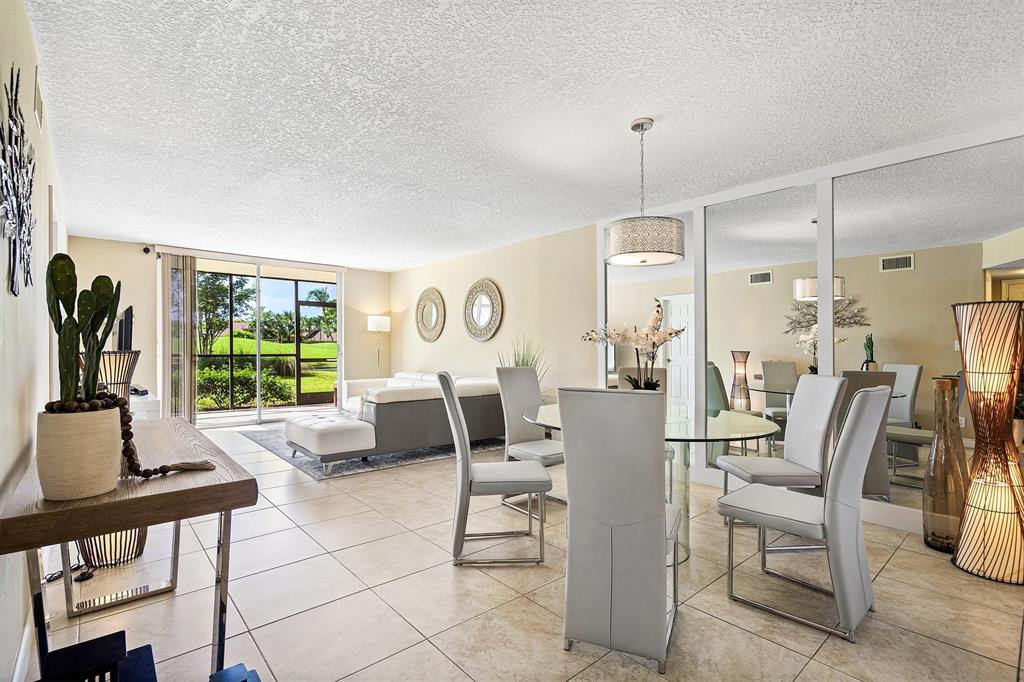 2440 DC Country Club Boulevard, Unit 111C Deerfield Beach, FL 33442 - Photo 6 of 43 a living room with furniture and a large window