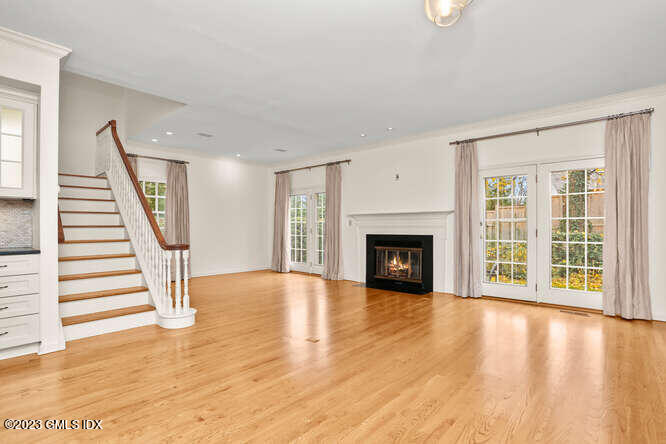 28 Home Place, Unit B1 Greenwich, CT 06830 - Photo 1 of 22 a view of an empty room with wooden floor fireplace and a window