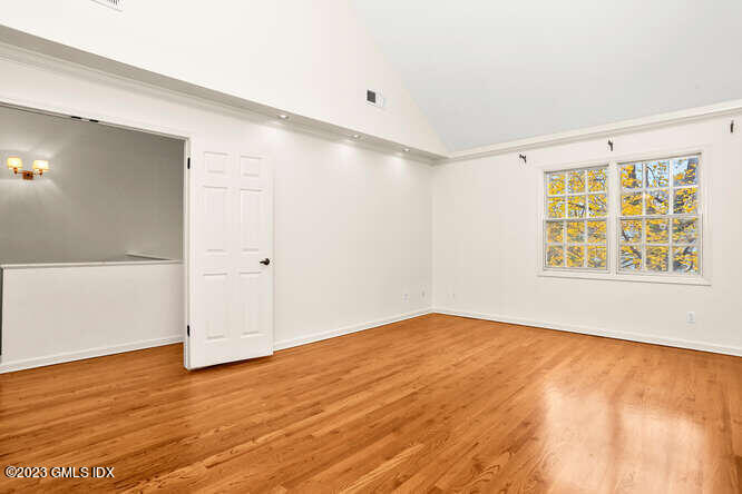 28 Home Place, Unit B1 Greenwich, CT 06830 - Photo 12 of 22 a view of an empty room with wooden floor and a window
