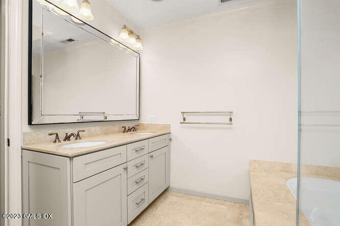 28 Home Place, Unit B1 Greenwich, CT 06830 - Photo 15 of 22 a bathroom with a sink and a mirror