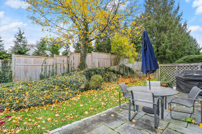 28 Home Place, Unit B1 Greenwich, CT 06830 - Photo 19 of 22 a view of backyard with table and chairs and wooden fence