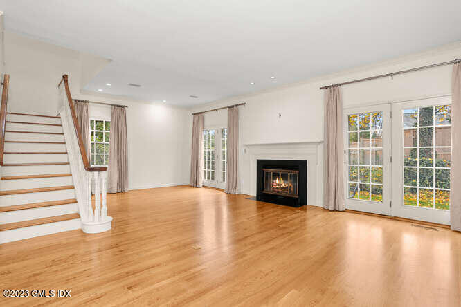 28 Home Place, Unit B1 Greenwich, CT 06830 - Photo 5 of 22 a view of an empty room with wooden floor fireplace and a window