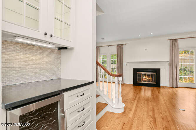 28 Home Place, Unit B1 Greenwich, CT 06830 - Photo 7 of 22 a view of a livingroom with wooden floor and a fireplace