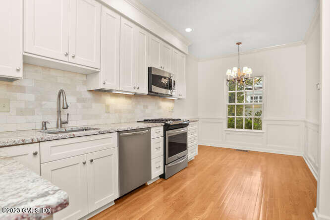 28 Home Place, Unit B1 Greenwich, CT 06830 - Photo 9 of 22 a kitchen with stainless steel appliances granite countertop a sink a stove a microwave and cabinets