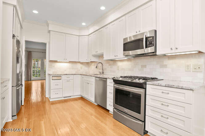 28 Home Place, Unit B1 Greenwich, CT 06830 - Photo 10 of 22 a kitchen with stainless steel appliances granite countertop a stove a microwave and a refrigerator