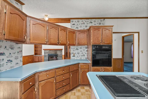 a kitchen with stainless steel appliances granite countertop a sink and wooden cabinets