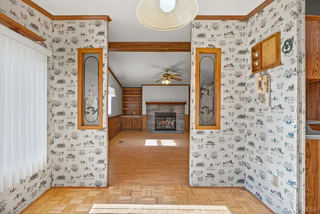 a view of an empty room with a fireplace and a window