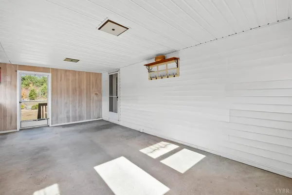 an empty room with windows and closet