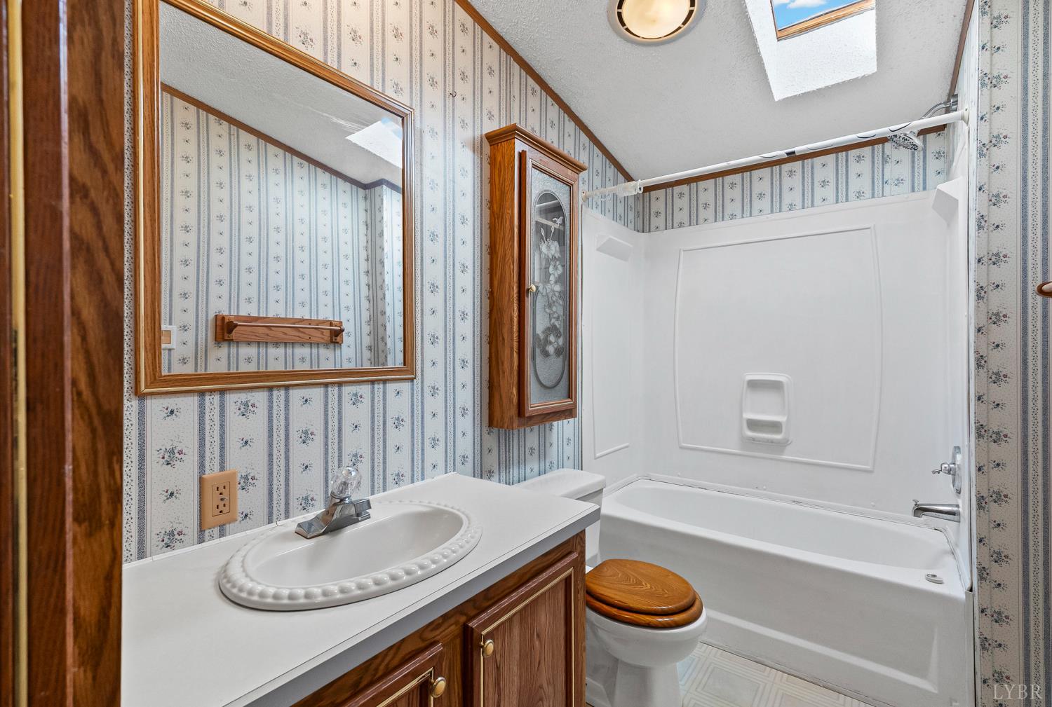 1821 Telegraph Road Gretna, VA 24557 - Photo 29 of 54 a bathroom with a granite countertop sink mirror vanity and a bathtub