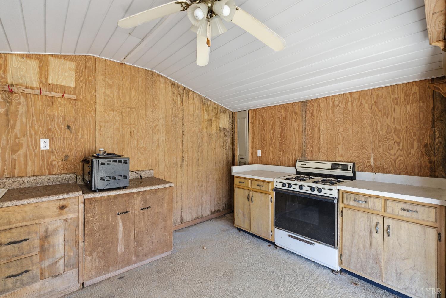 1821 Telegraph Road Gretna, VA 24557 - Photo 41 of 54 a kitchen with white cabinets and appliances