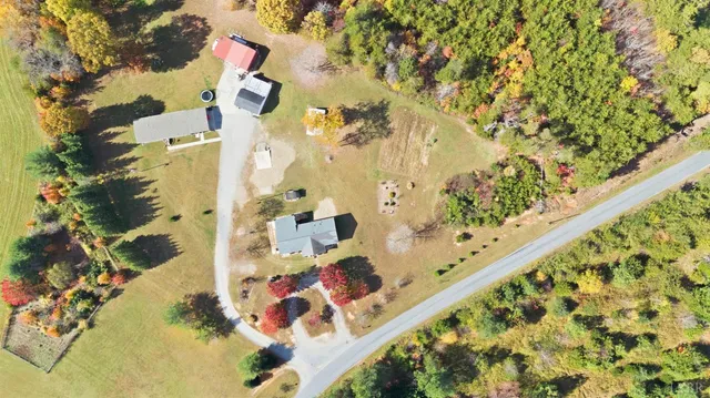 an aerial view of a houses with a yard