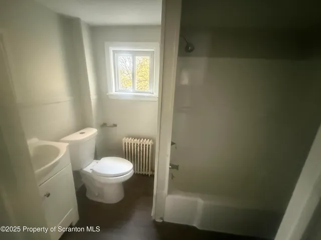 a bathroom with a toilet and a sink