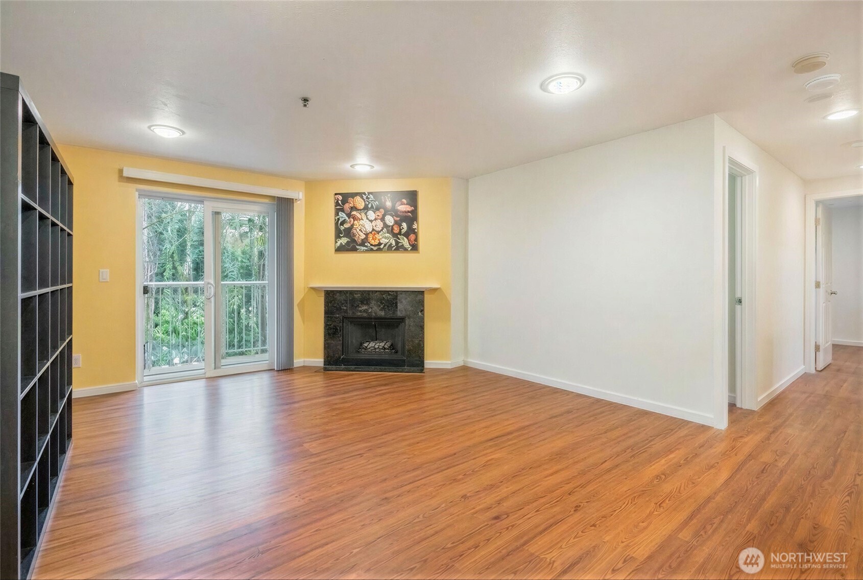 975 Aberdeen Avenue Northeast, Unit F207 Renton, WA 98056 - Photo 3 of 24 a view of an empty room with wooden floor and a window