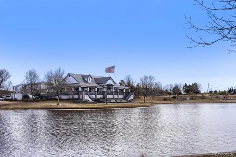 a view of ocean with boats and trees in the background