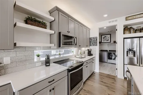 a kitchen with a sink stainless steel appliances and cabinets